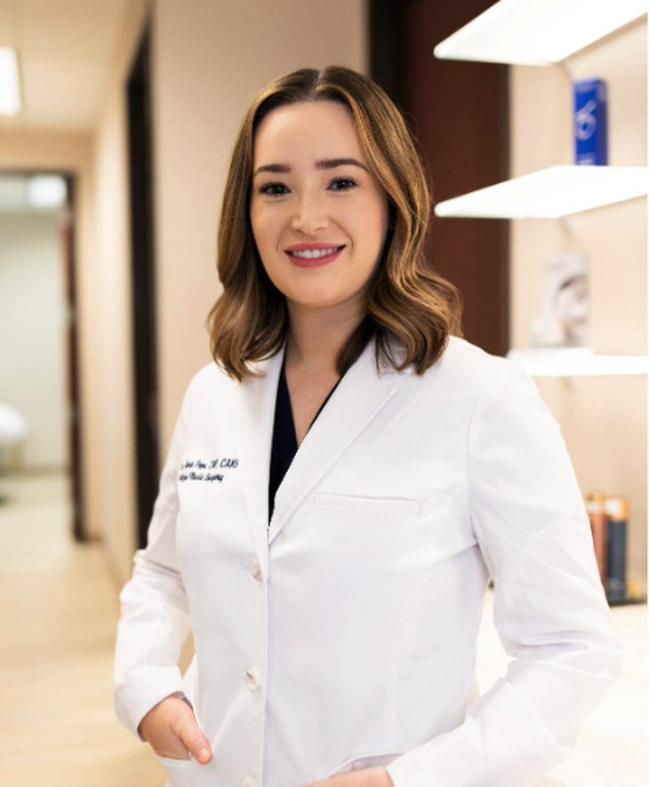 Eva Marie E. Pope, board-certified nurse practitioner, smiling in a white coat
